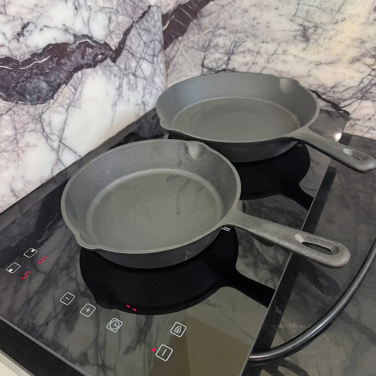 Cast iron cookware heating on both cooktop zones