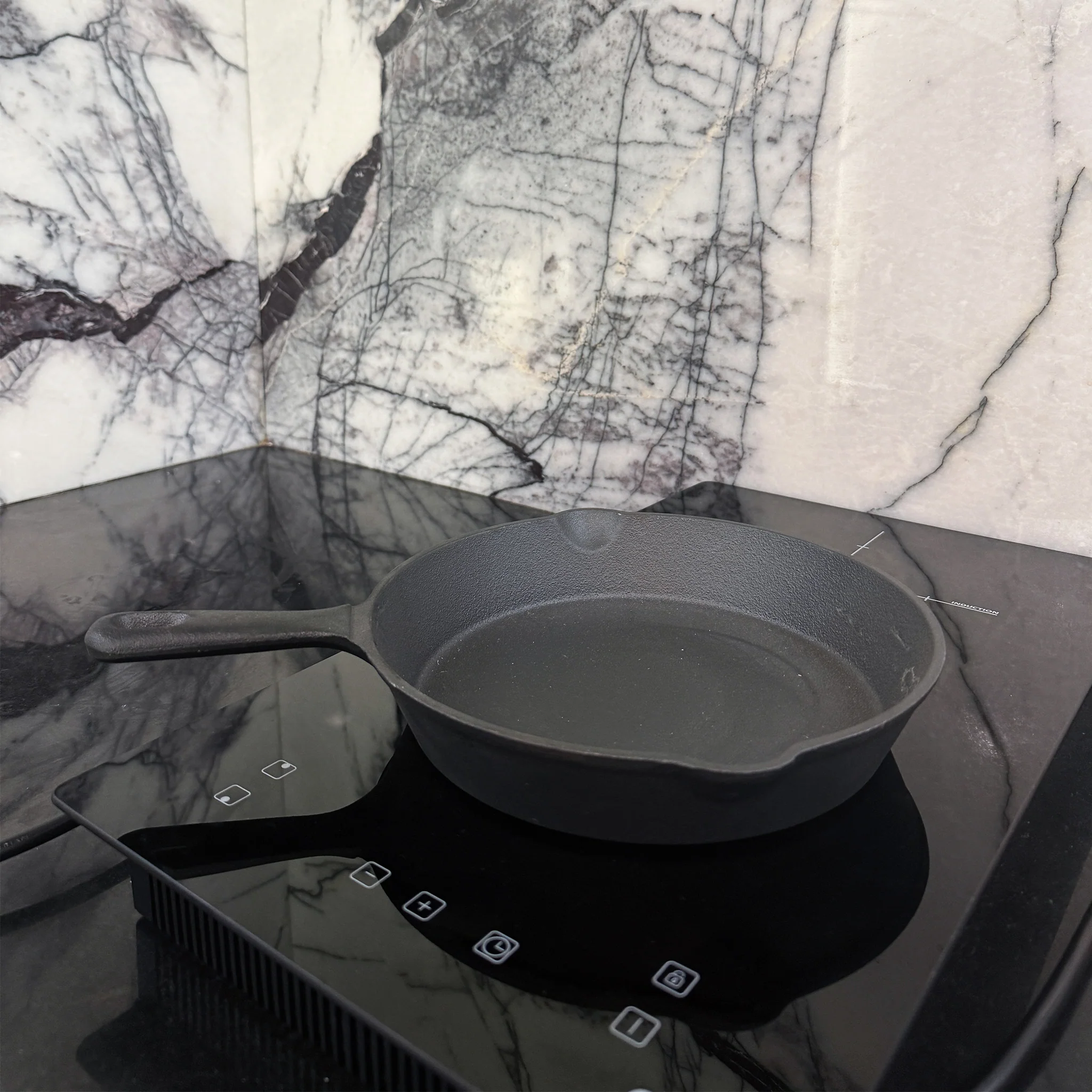 Cast iron pan in use on the cooktop