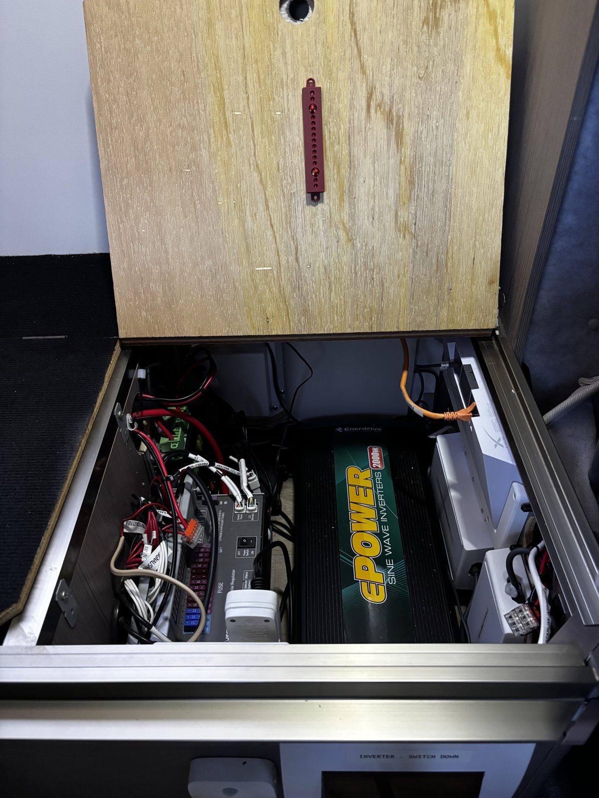 Ferosticker strip device on a timber lid over an inverter and battery bay