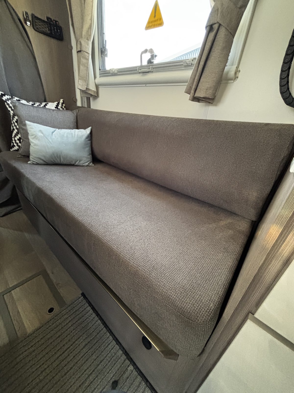 RV dinette seat with enclosed storage beneath the cushion