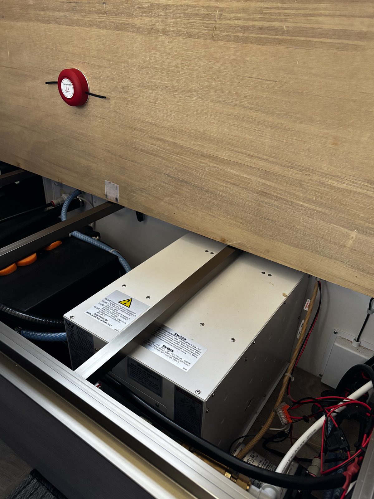 Round Ferosticker device on a lid above an inverter or charger unit