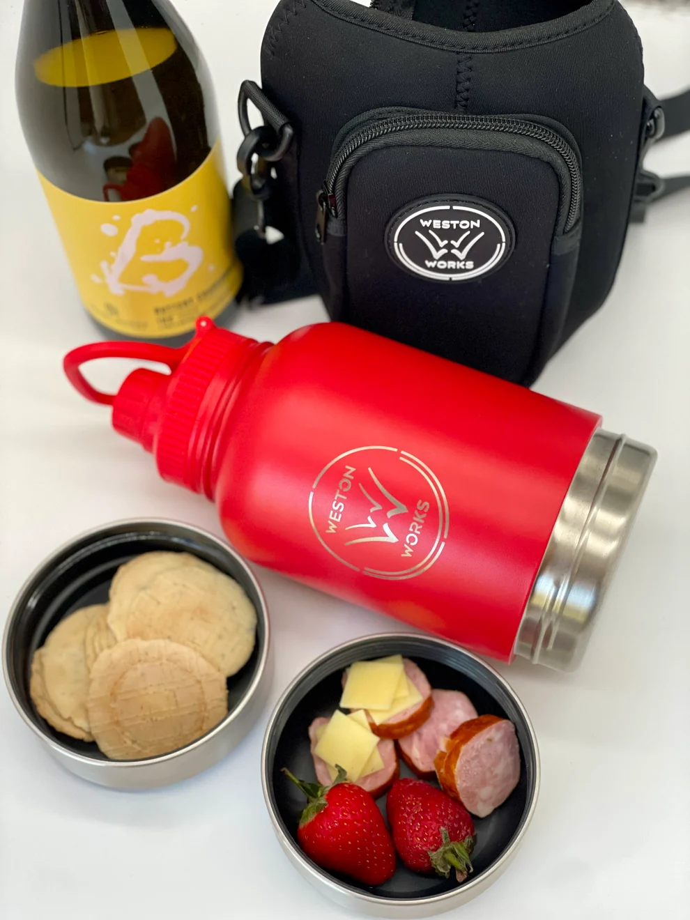 WestonWorks First Aid Bottle styled with wine, biscuits, cured meat and strawberries
