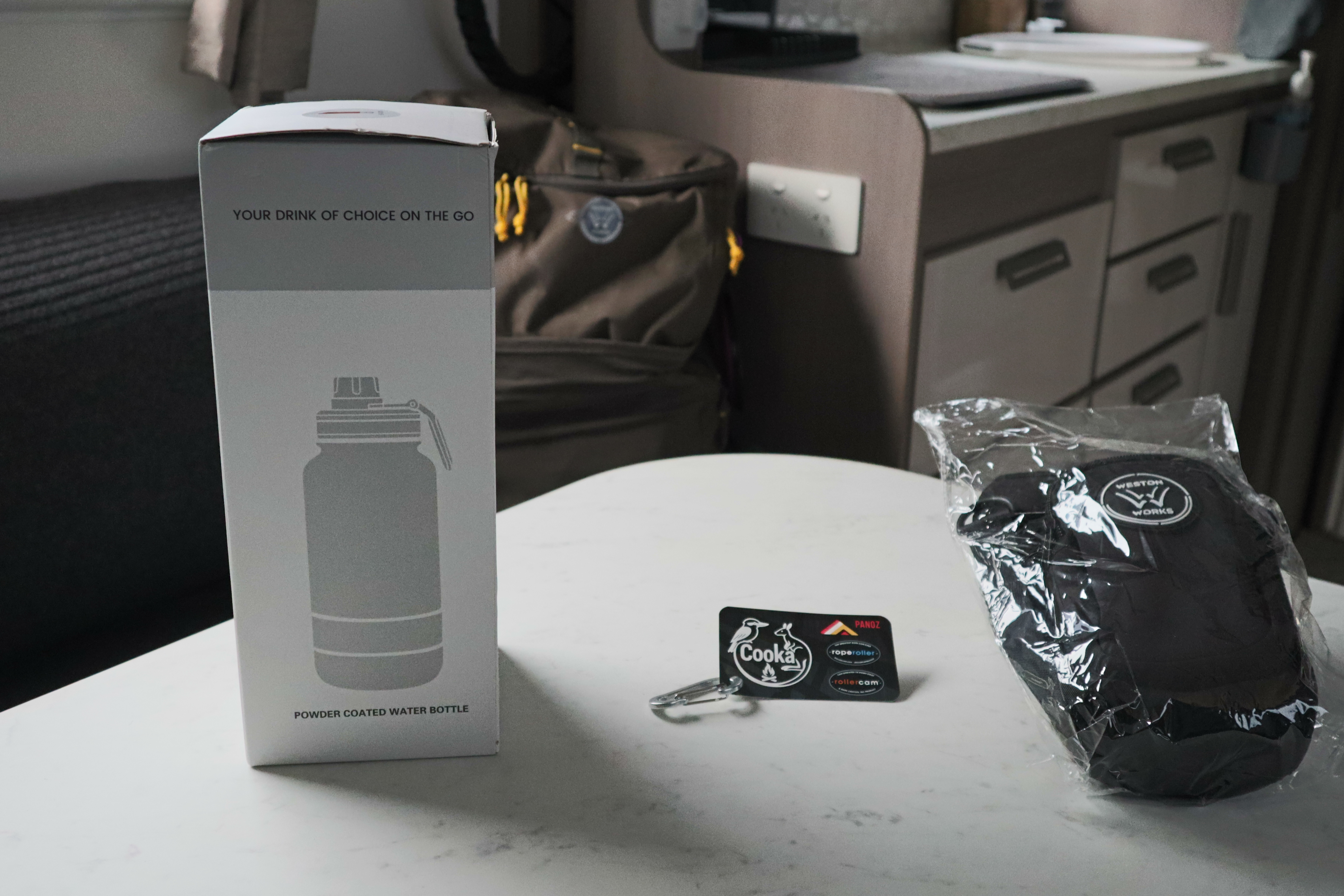WestonWorks First Aid Bottle box, branded keyring and wrapped carry pouch on a table